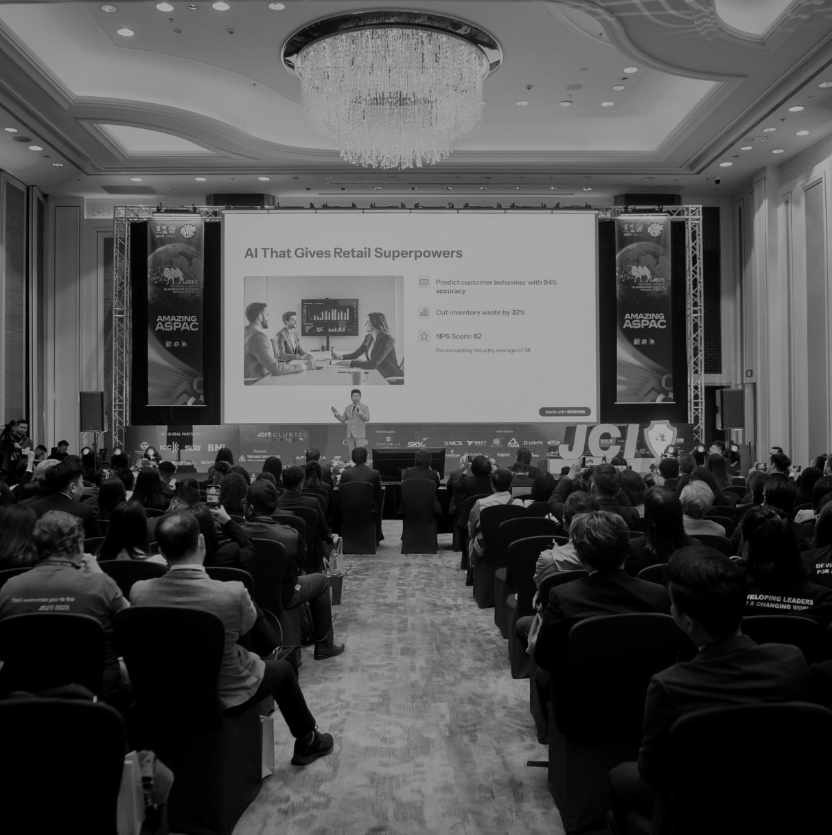 A founder pitching on the main stage to a packed ballroom at the JCI Asia–Pacific Conference